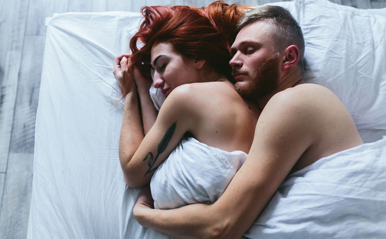 Loving couple embracing in bed