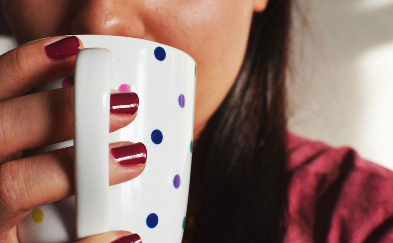 Close-up of a woman drinking morning coffee