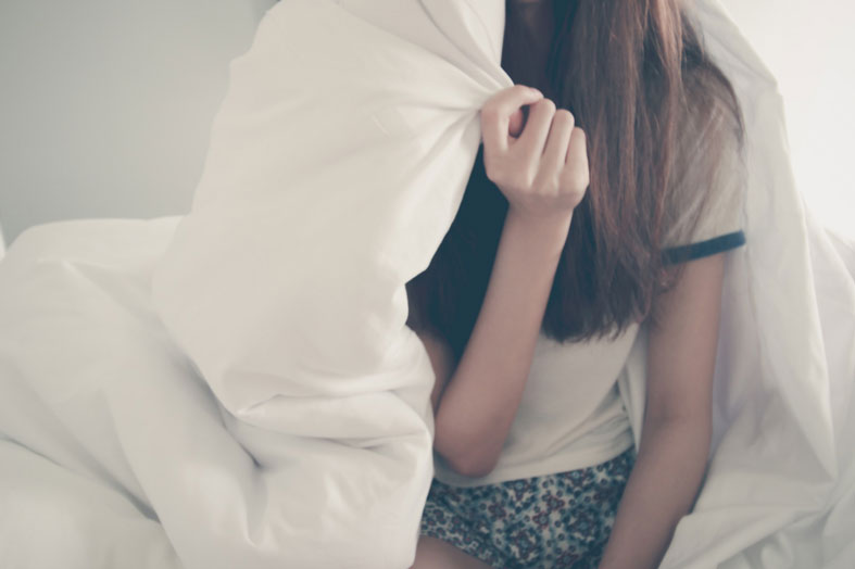 stress-free happy woman covered with blanket stress free