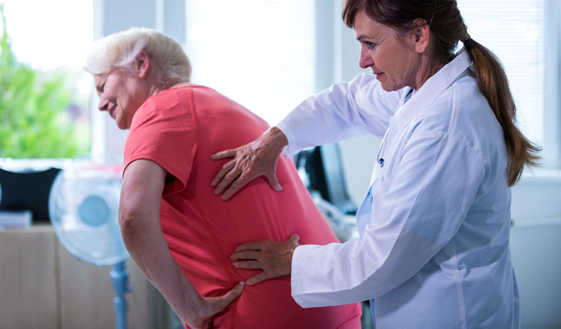 older woman with back pain problem at the doctor