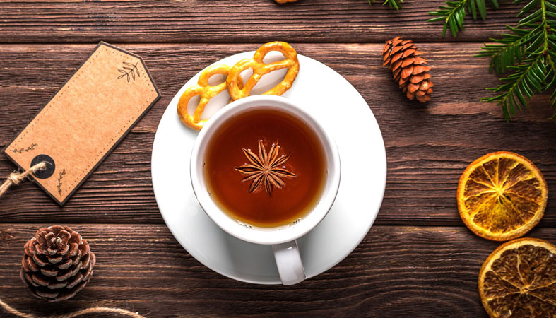 cinnamon-tea cinnamon cup with dry oranges and crackers