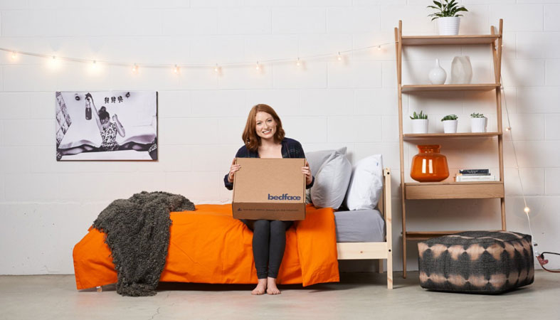 happy woman in the room holding a bedface box