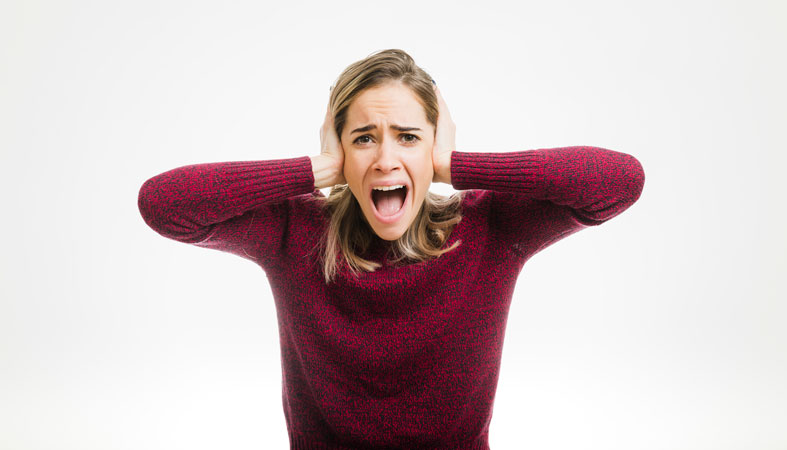 woman disgusted by loud noise