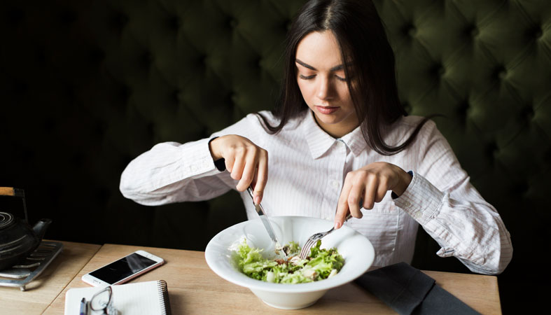 woman eating salad