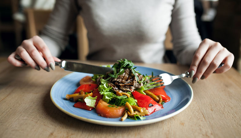 woman is eating a healthy meal