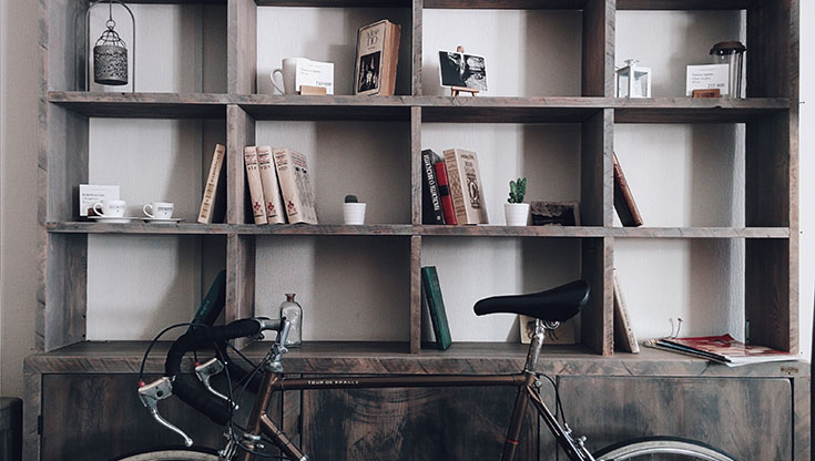 Modern Minimalist Bedroom Ideas – 7 Tips to Declutter Space 3 Bookshelf with a bike