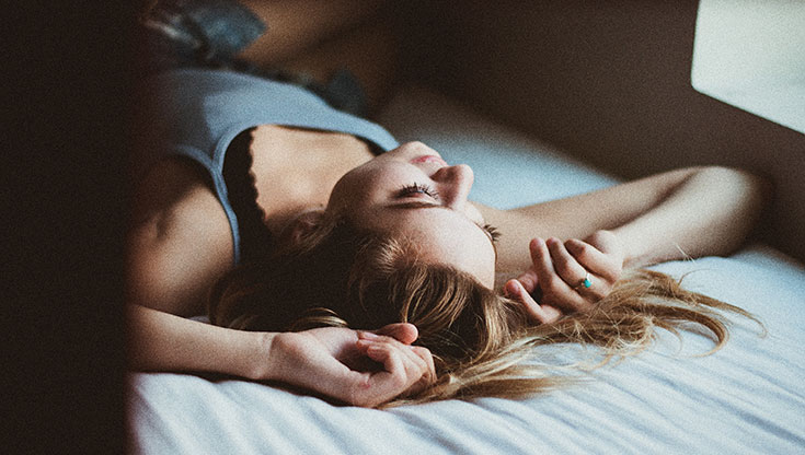 Girl is laying on the bed