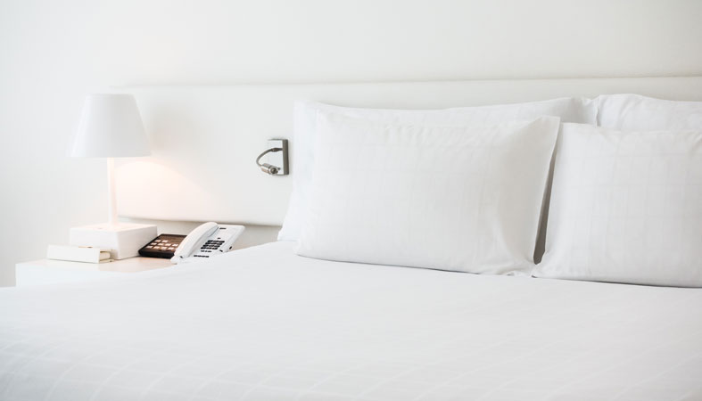 white bed with white pillows