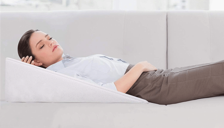 woman is lying on wedge pillow
