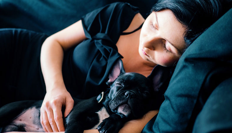 woman is sleeping with her dog