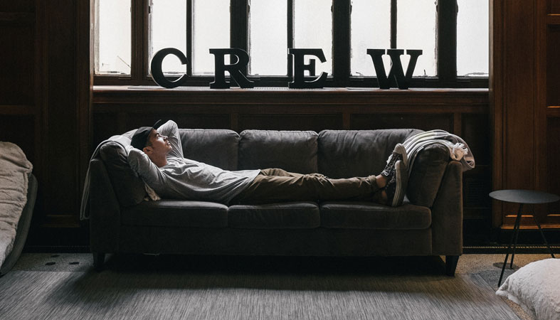 man is relaxing on sofa