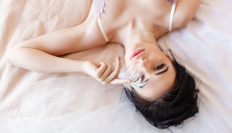 sensual brunette lying on bed