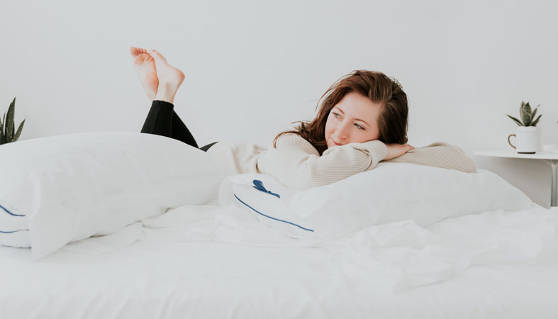 the girl is lying on nectar bed