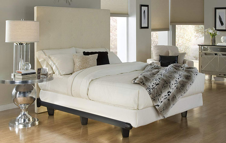 mattress on bed frame in bedroom