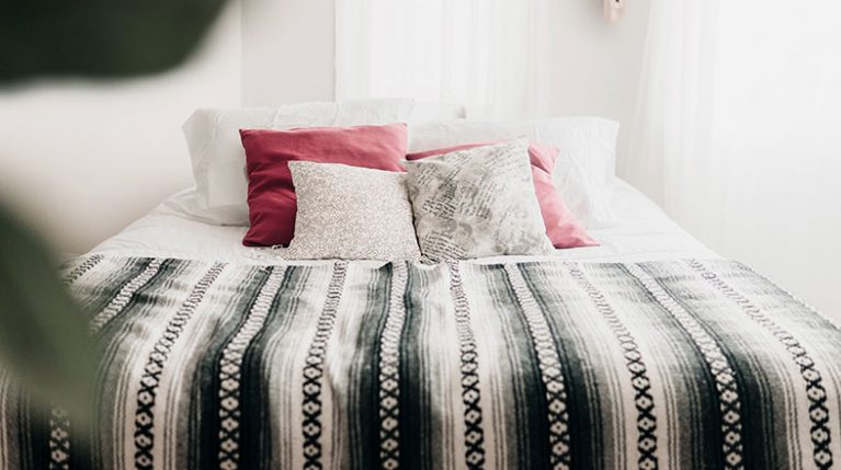 tidy bed with beautiful pillows