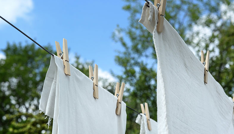 white sheets cover are drying outside