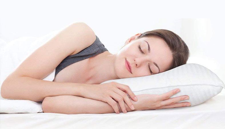 woman is peacefully sleeping on the pillow