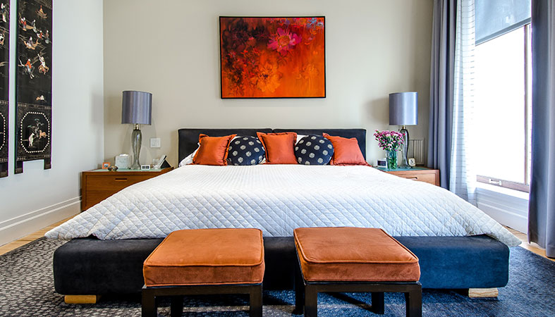 a-bedroom-with-a-big-bed-and-a-lot-of-colorful-pillows a bedroom with a big bed and a lot of colorful pillows