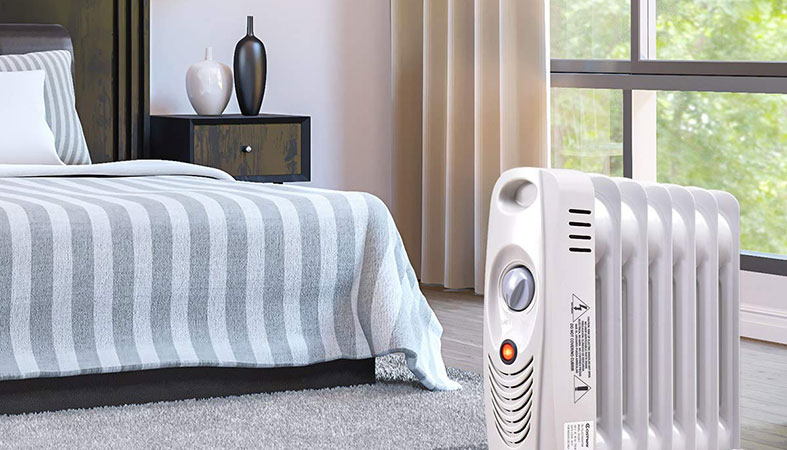 a bedroom with an oil filled radiator in it