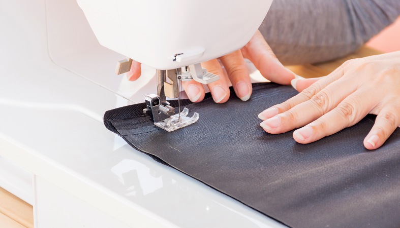 close up photo of the womans hand sewing