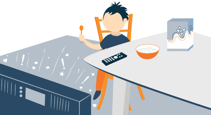 School-aged Child watching TV while Having Breakfast