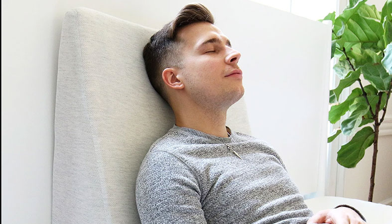 Our In Depth Helix Wedge Pillow Review for 2025 4 a man is laying on the helix wedge pillow