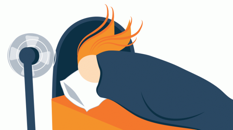 Woman sleeping while fan is cooling her off