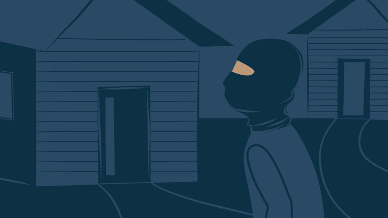 illustration of a man wearing all black crouches by the front door of a house