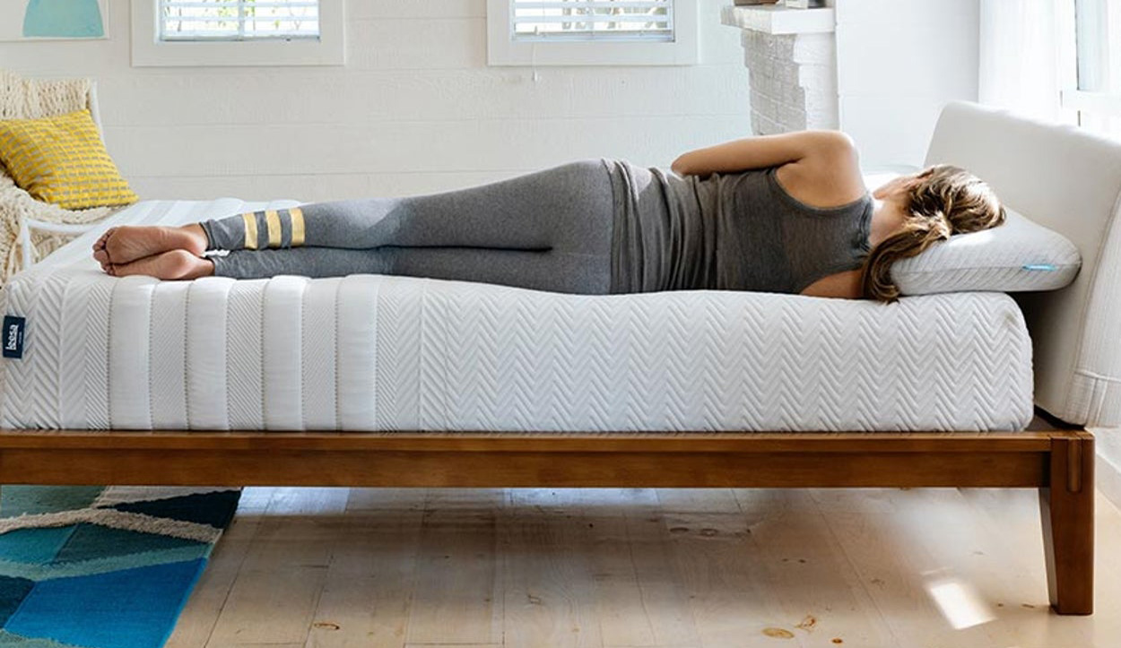 Product image of Leesa Legend mattress with a woman lying on the edge
