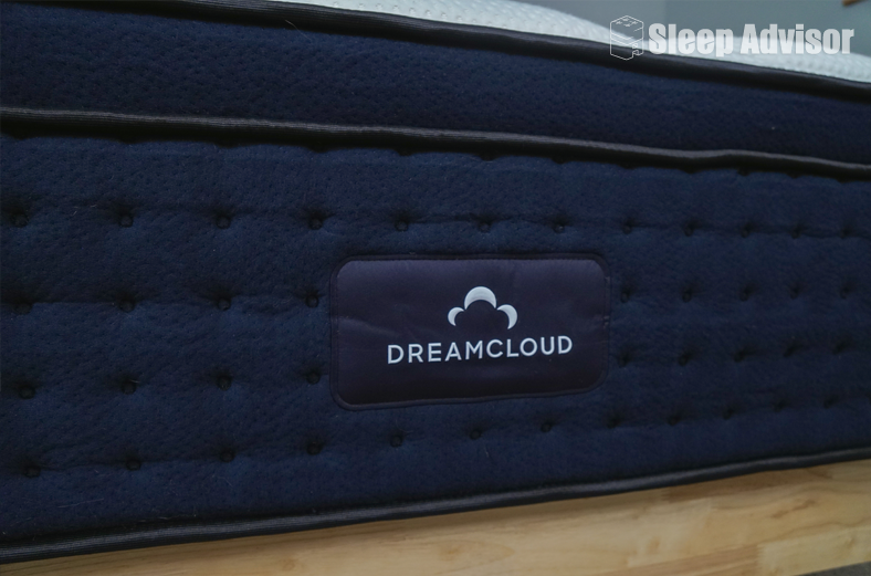 dreamcloud premier closeup image showing the logo on the front of the mattress