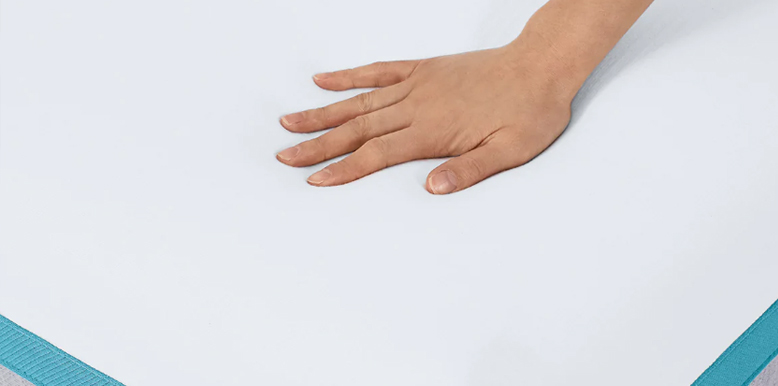 a picture of a hand squeezing a mattress