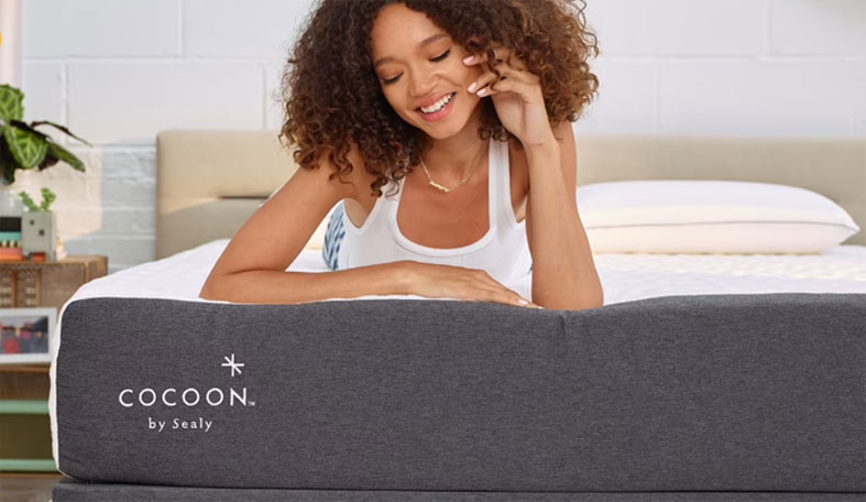 happy woman is lying on her stomach on a cocoon chill bed