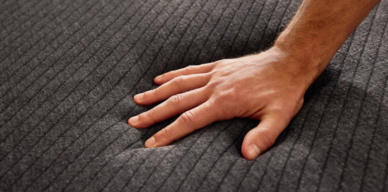 hand-is-pushing-the-pod-mattress hand is pushing the pod mattress