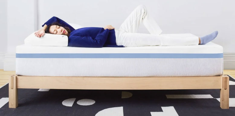 a woman is lying on the helix moonlight mattress