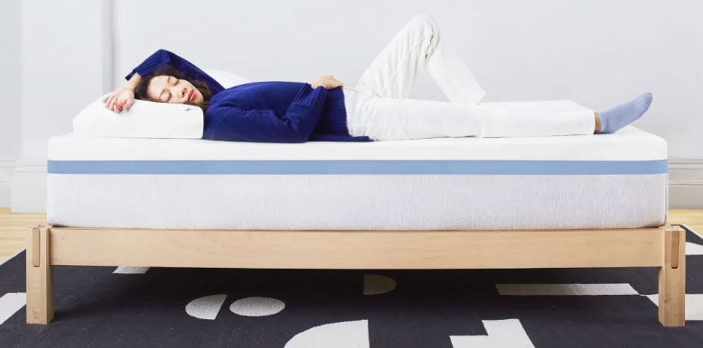 a-woman-is-lying-on-the-helix-moonlight-mattress a woman is lying on the helix moonlight mattress