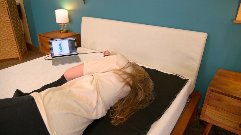 Julia Forbes testing a mattress for pressure relief