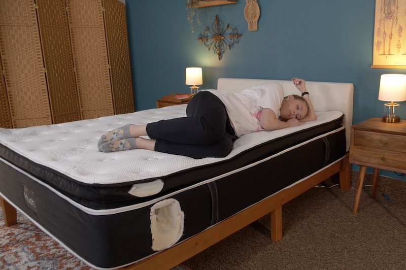 Julia Forbes testing a mattress in the side sleeper sleeping position
