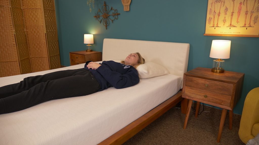 Julia Forbes testing a mattress for back sleeping