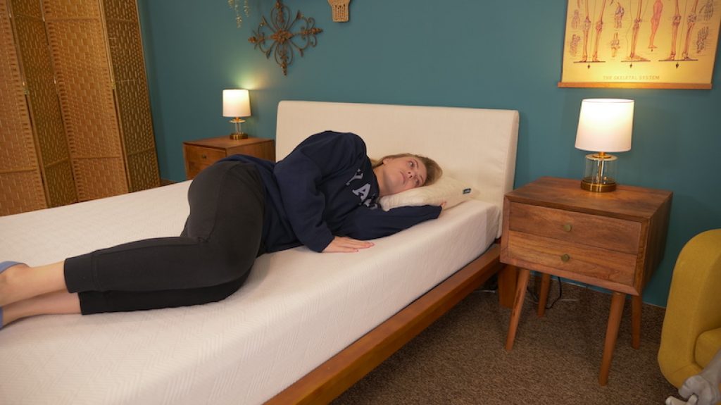 Sleep Advisor’s Product Review Process 6 Julia Forbes testing a mattress for side sleeping