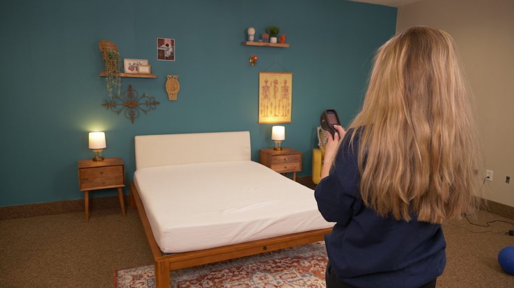 Best Firm Mattress Toppers (2025) - Expert Tested 13 Julia Forbes testing temperature dissipation on a mattress