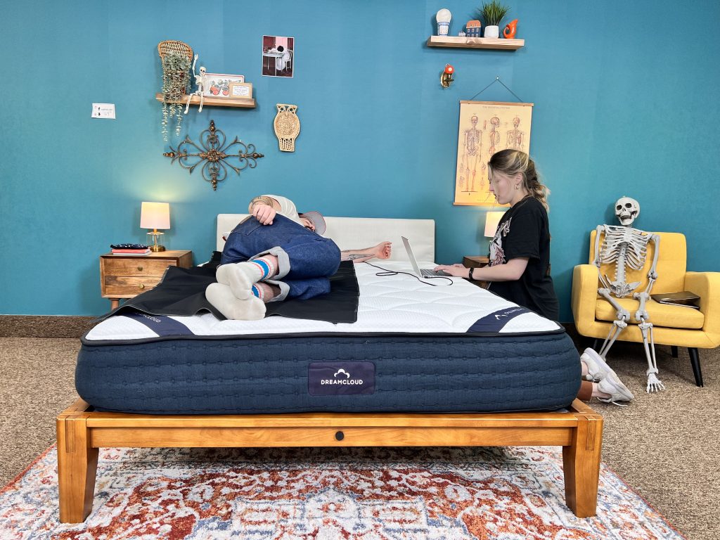 Our testers testing the DreamCloud Foam mattress in the studio