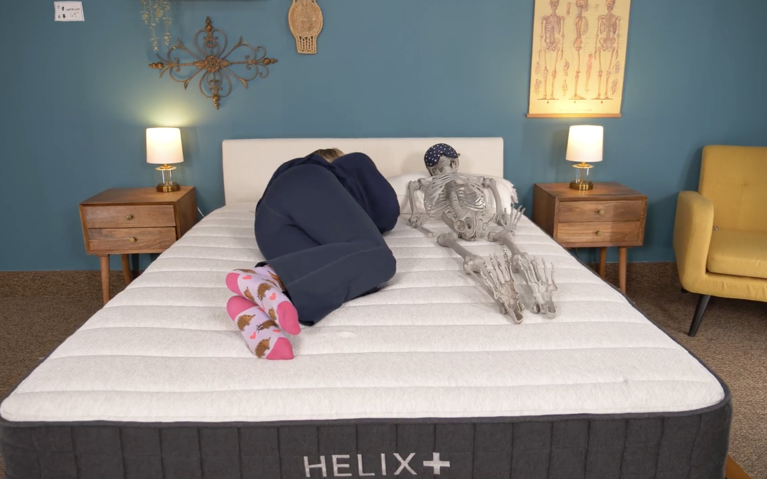 Julia and resident skeleton Dave testing the motion isolation of the Helix Plus mattress