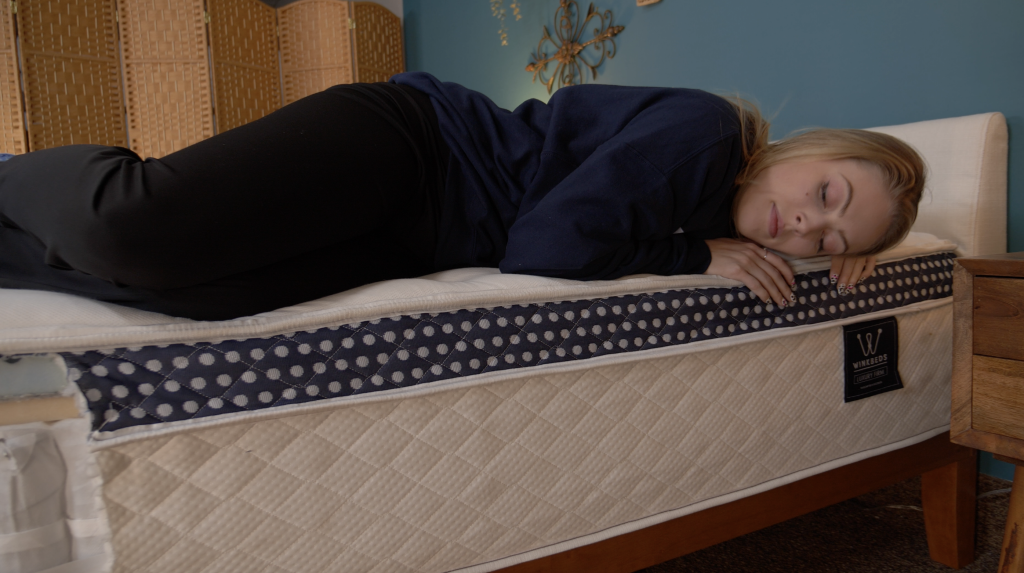 Julia Forbes testing edge support in the Winkbed mattress
